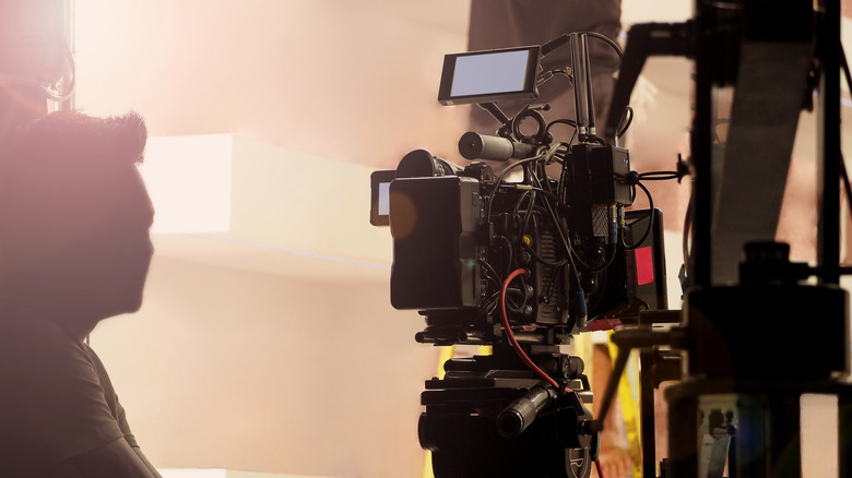 A film operator handling a camera on a set.