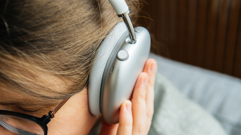 A person wearing Apple AirPods Max.