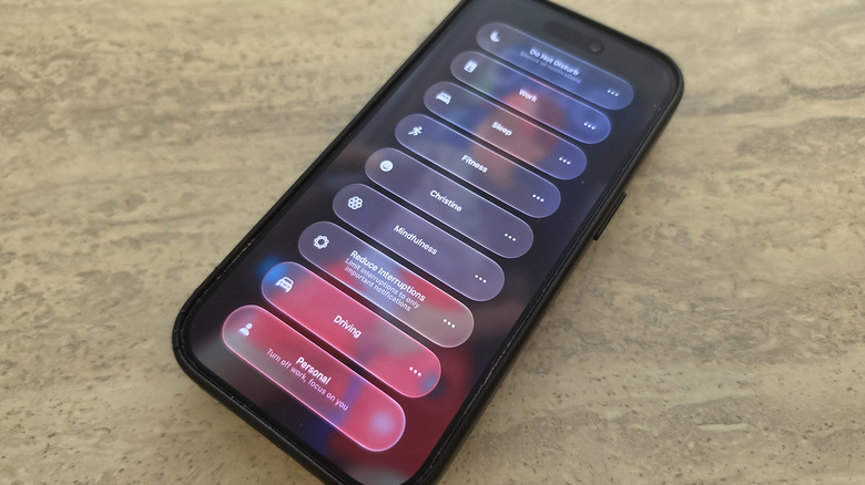 An iPhone lying on a table showing Focus mode options.