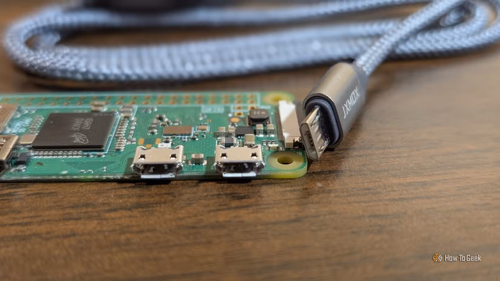 A Raspberry Pi Zero 2 W next to a USB-C to micro USB cable. 